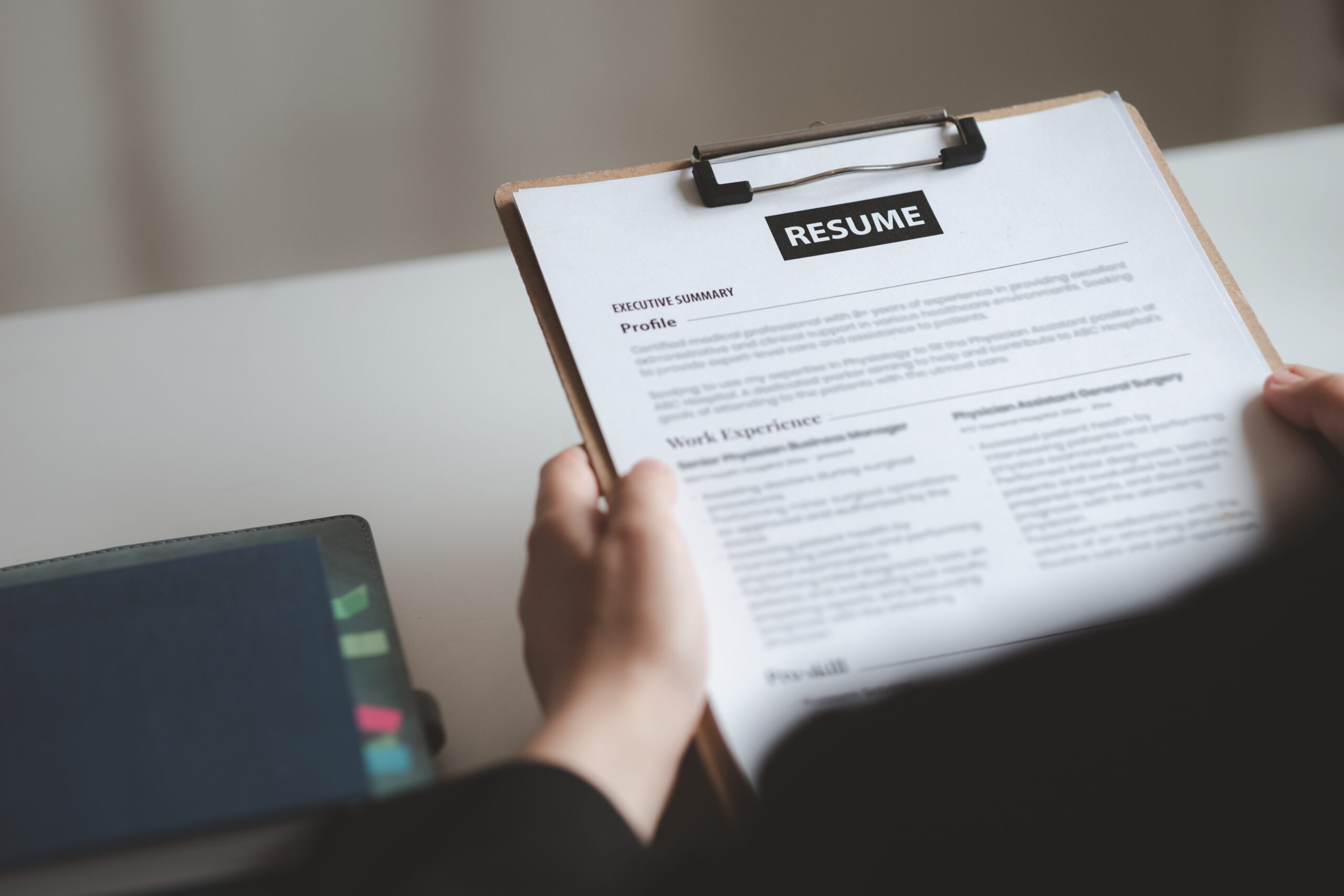Career professional reviewing a strategic résumé document at a modern desk